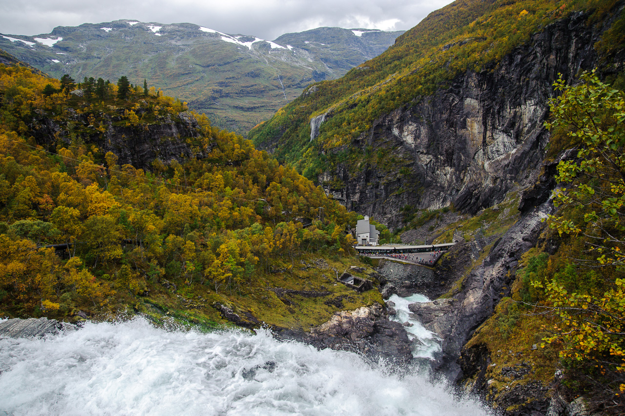 A Myrdal bound train on the Flåm line makes a halt at Kjosfossen to let tourist capture the forces of the waterfall. 